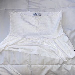 White crop top with frilly thing on the bottom